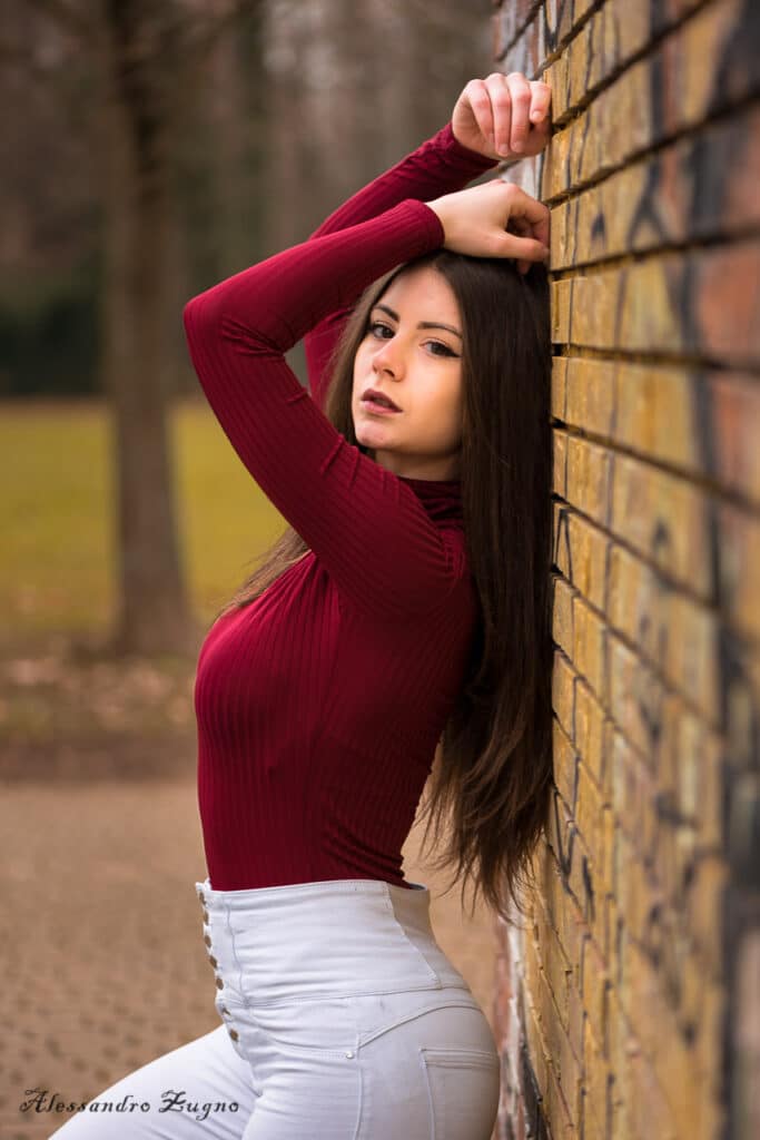 ragazza appoggiata a muro per foto in esterna